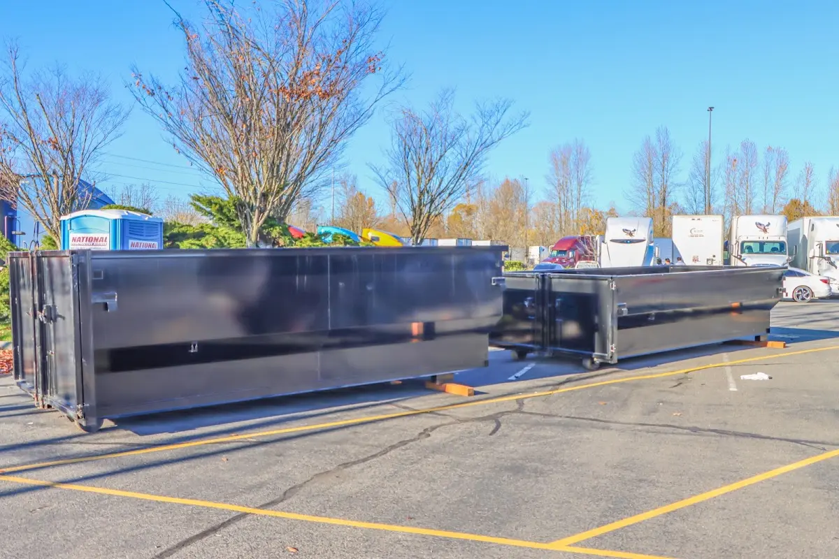 Professional dumpster rental service with roll-off container on residential driveway in Earlimart